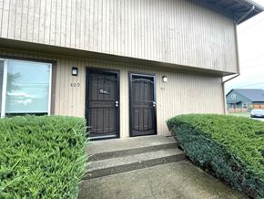 Kelso apartment for rent - The image shows a building with two black doors, one of which is numbered 409.