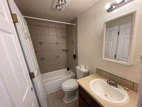 Kelso apartment for rent - A white toilet sits next to a white bathtub in a bathroom.