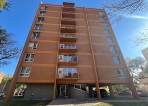 Regina apartment for rent - A tall apartment building with a balcony on the second floor.