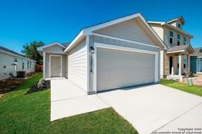 San Antonio house for rent - a white house with a garage door on a driveway