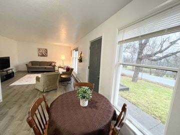 Ithaca apartment for rent - the dining room and living room of a house with a large window