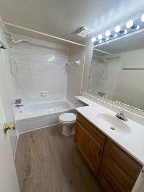 Columbia house for rent - A white bathroom with a wooden vanity and a white toilet.