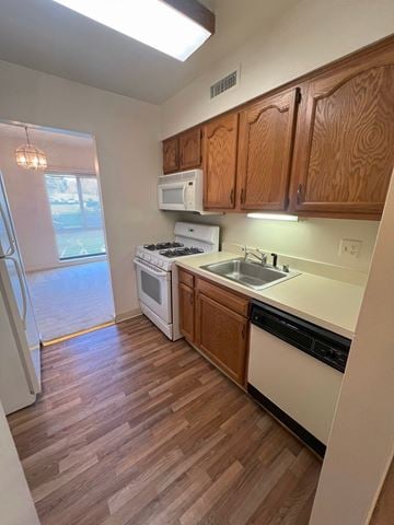 Columbia house for rent - A kitchen with wooden cabinets and a white fridge.