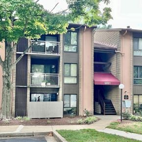 Columbia house for rent - Apartment building with balconies and a red awning.