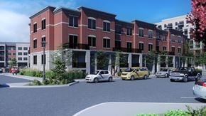 Kitchener apartment for rent - A street view of a red brick building with cars parked in front.