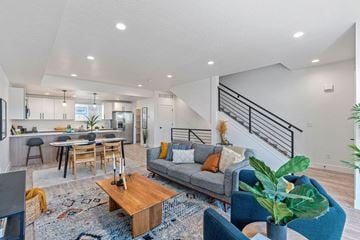 Salt Lake City apartment for rent - a living room with a couch and a kitchen with a staircase