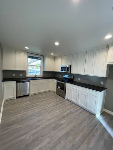 Abilene house for rent - A kitchen with white cabinets and a grey floor.