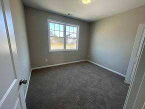 Wilson house for rent - a empty room with gray walls and a window