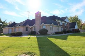 Crown Point apartment for rent - a large brick house with a lawn in front of it