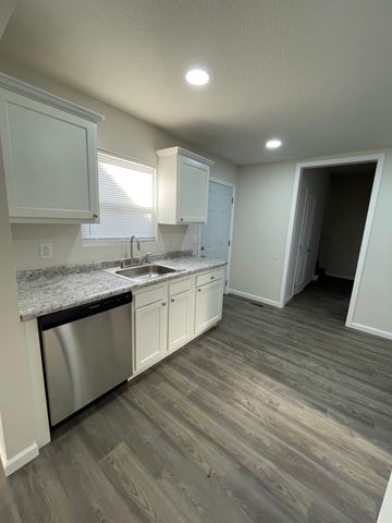 Lima apartment for rent - A kitchen with a stainless steel dishwasher and white cabinets.