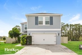 Davenport house for rent - a gray house with a white garage door and a lawn