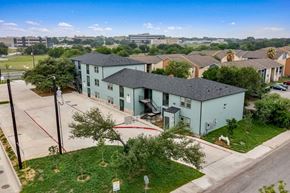 San Antonio apartment for rent - a group of houses in a neighborhood with a city in the background