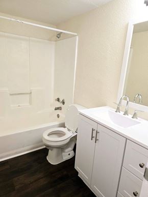 Atoka apartment for rent - A white toilet sits in a bathroom next to a sink.