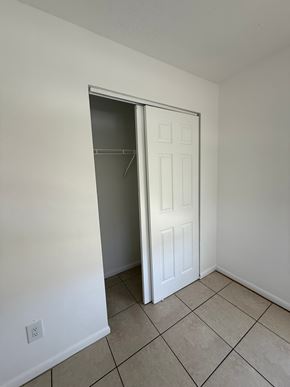 Fort Myers apartment for rent - A white door is open in a room with tiled flooring.