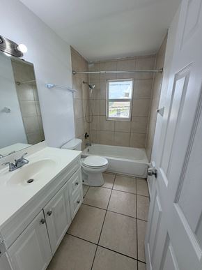 Fort Myers apartment for rent - A white bathroom with a sink, toilet, and bathtub.