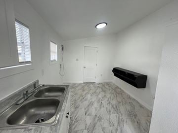 Fort Myers apartment for rent - A kitchen with two sinks and a marble floor.