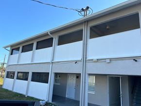 Fort Myers apartment for rent - A white building with a blue sky in the background.