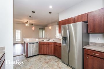 Lakeland house for rent - a kitchen with stainless steel appliances and wooden cabinets