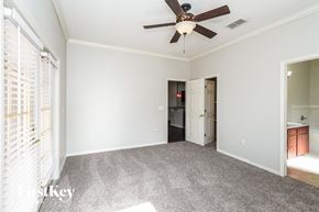 Lakeland house for rent - a living room with a ceiling fan and a door to a bathroom