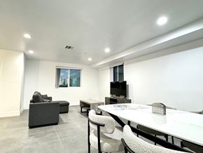 Los Angeles apartment for rent - a living room with a table and chairs and a television