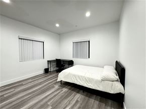 Los Angeles apartment for rent - a bedroom with a bed and a desk and two windows