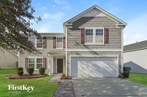 Charlotte house for rent - a beige house with a white garage door