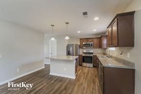 Charlotte house for rent - a kitchen with wood flooring and stainless steel appliances and