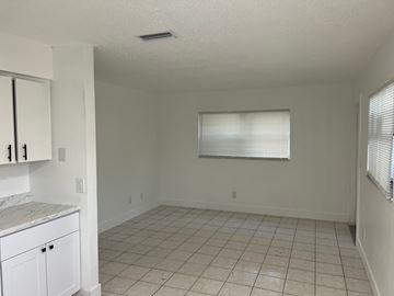 Fort Myers apartment for rent - A kitchen with white cabinets and a countertop is shown.
