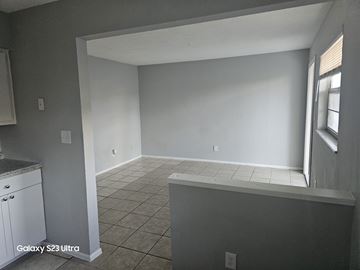 Fort Myers apartment for rent - A kitchen with white cabinets and a tiled floor.