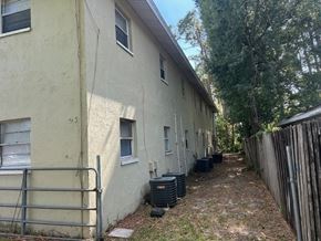 Fort Myers apartment for rent - A white building with a gate in front of it.