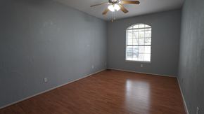 Mesquite house for rent - an empty living room with wood floors and a window