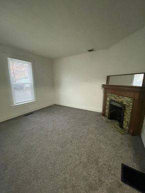 Lima apartment for rent - A room with a fireplace and a window.