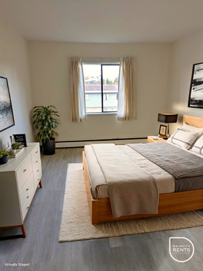 Surrey apartment for rent - A bedroom with a bed, nightstand, and window.