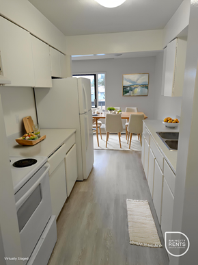 Surrey apartment for rent - A kitchen with white appliances and cabinets.