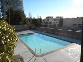 West Vancouver apartment for rent - A swimming pool surrounded by a concrete wall and a metal ladder.
