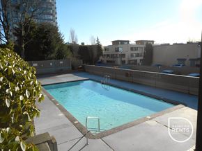 West Vancouver apartment for rent - A swimming pool surrounded by a concrete wall and a metal ladder.