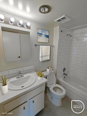 West Vancouver apartment for rent - A bathroom with a white toilet, sink, and bathtub.