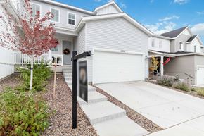 Castle Pines house for rent - a white house with a driveway and a garage door