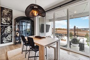 Castle Pines house for rent - a dining area with a wooden table and black chairs and a view of a patio