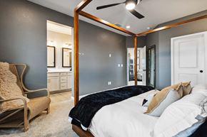 Castle Pines house for rent - the master bedroom has a large bed and a ensuite bathroom