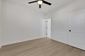 Houston apartment for rent - a living room with white walls and a ceiling fan