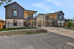 Houston apartment for rent - a street view of three houses with a fence