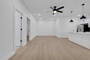 Houston apartment for rent - a living room with white walls and a ceiling fan