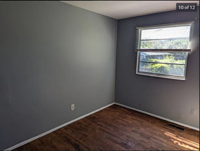 St. Louis house for rent - an empty room with a window and wooden floors