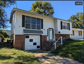St. Louis house for rent - a white house with a white door and a white garage