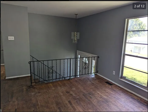 St. Louis house for rent - an empty living room with a wood floor and a window