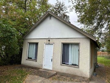 Prince Albert house for rent - a small white house with a white door and two windows