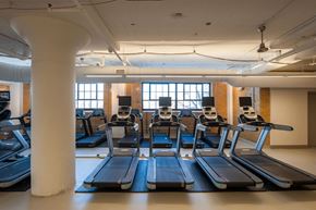 Cleveland apartment for rent - A gym with treadmills and a white column.