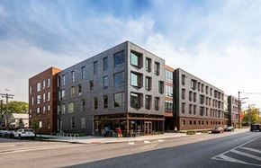 Cleveland apartment for rent - A modern multi-story building with a mix of brick and glass facade.