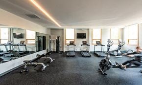 Cleveland apartment for rent - A gym with a variety of equipment including treadmills, stationary bikes, and weight machines.